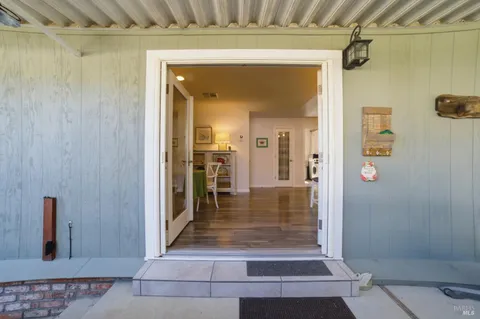 a view of a hallway with wooden shelves