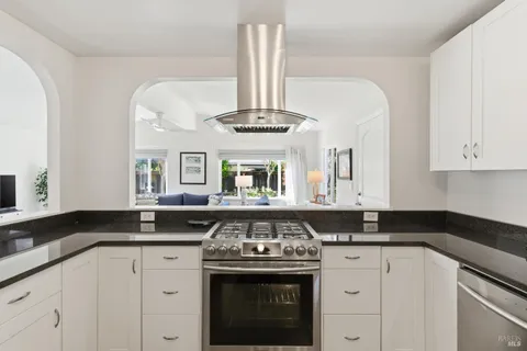 a kitchen with stainless steel appliances granite countertop a stove and a sink