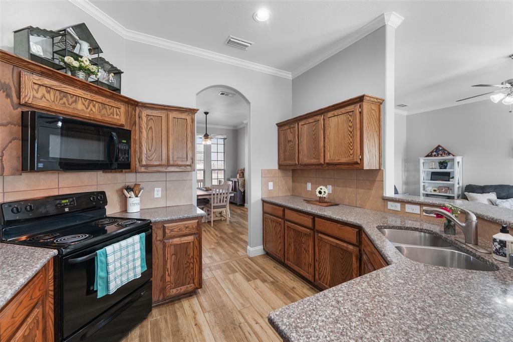 102 Avery Lane Fate, TX 75189 - Photo 11 of 30 a kitchen with a sink stove and microwave