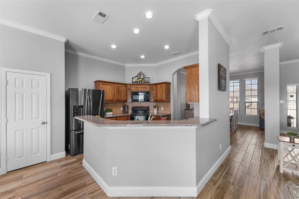 102 Avery Lane Fate, TX 75189 - Photo 12 of 30 a kitchen with stainless steel appliances granite countertop a refrigerator and a stove top oven