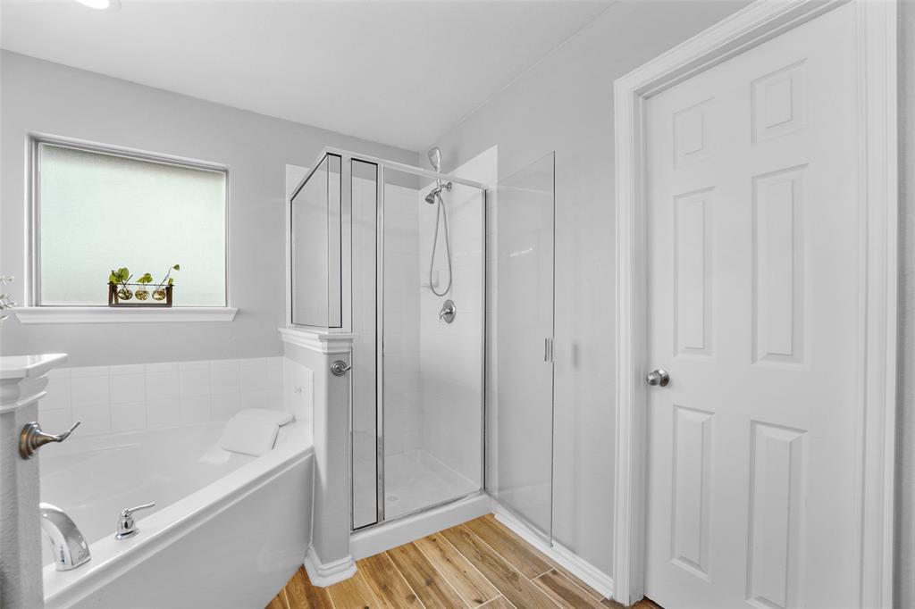 102 Avery Lane Fate, TX 75189 - Photo 17 of 30 a bathroom with a bathtub and a shower