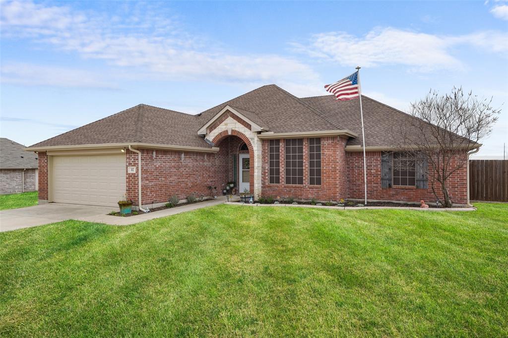 102 Avery Lane Fate, TX 75189 - Photo 2 of 30 a big house with a small yard and large trees