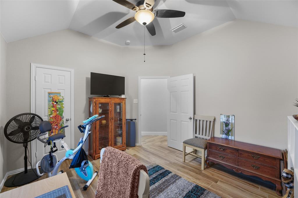 102 Avery Lane Fate, TX 75189 - Photo 21 of 30 a bedroom with furniture a flat screen tv and a window