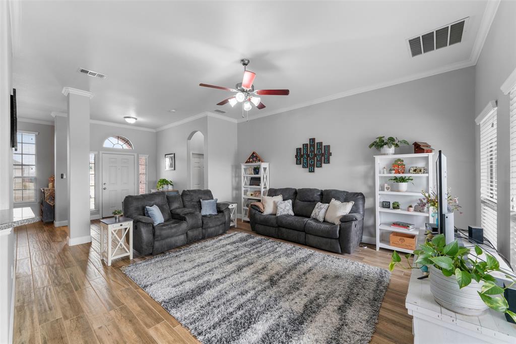 102 Avery Lane Fate, TX 75189 - Photo 7 of 30 a living room with furniture and a chandelier