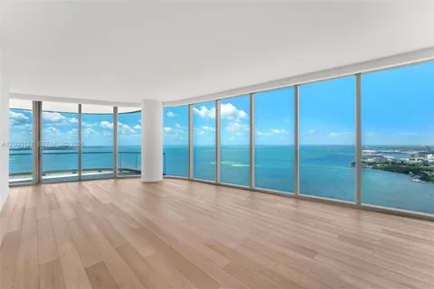 wooden floor in an empty room with a large window