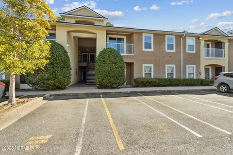 a view of a brick house with a yard