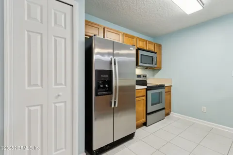 a kitchen with stainless steel appliances a refrigerator and a stove top oven