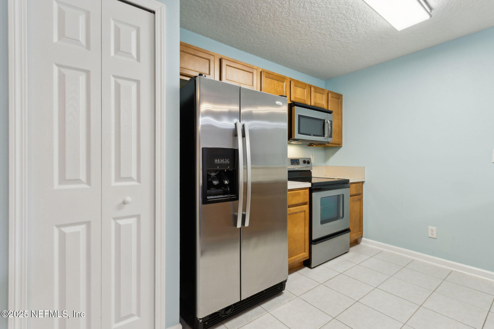 3700 Kirkpatrick Circle, Unit 811 Jacksonville, FL 32210 - Photo 13 of 29 a kitchen with stainless steel appliances a refrigerator and a stove top oven
