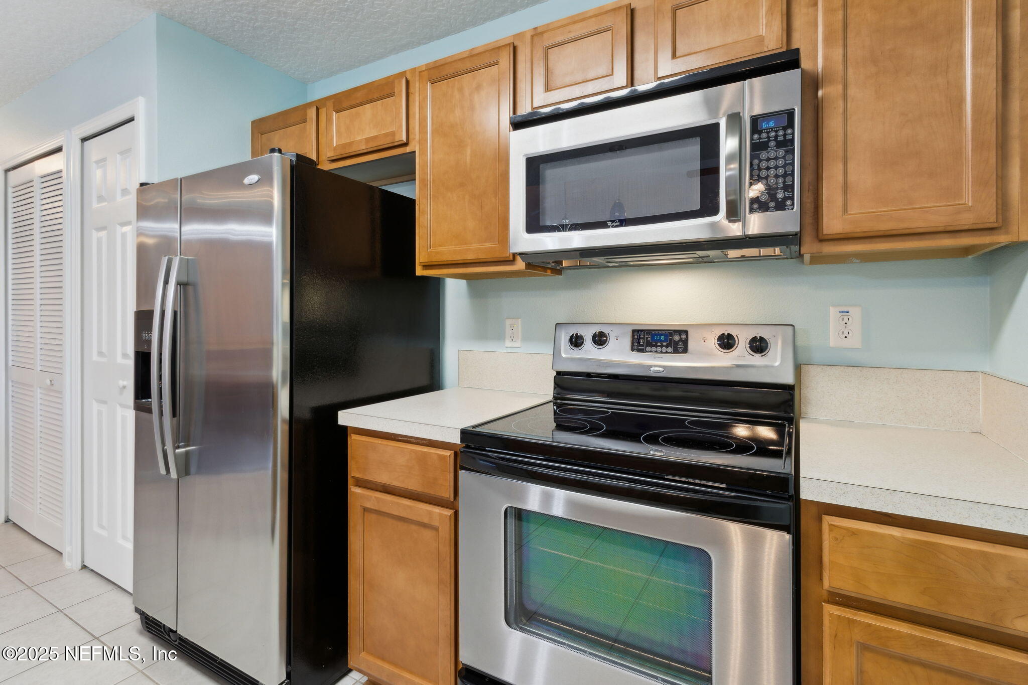 3700 Kirkpatrick Circle, Unit 811 Jacksonville, FL 32210 - Photo 15 of 29 a kitchen with stainless steel appliances granite countertop a stove microwave refrigerator and sink
