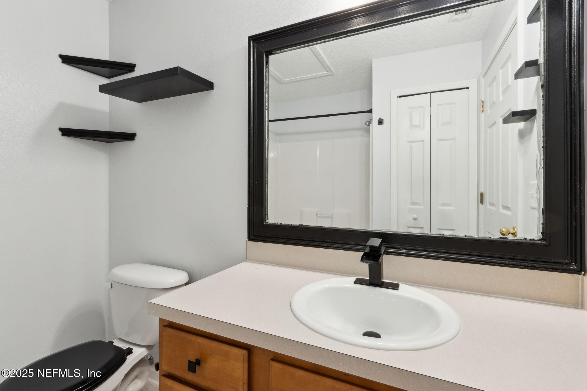 3700 Kirkpatrick Circle, Unit 811 Jacksonville, FL 32210 - Photo 25 of 29 a bathroom with a sink and a mirror