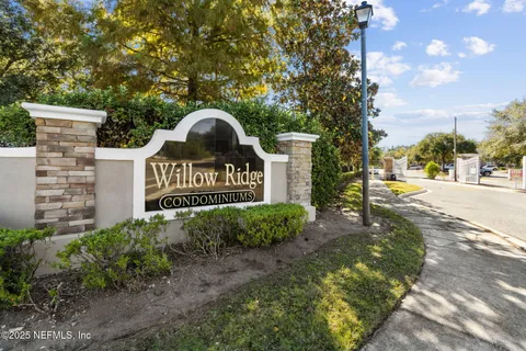 a view of a sign of a park next to a road