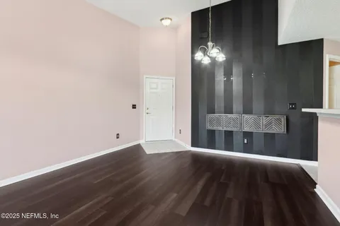 a view of a livingroom with furniture and chandelier fan