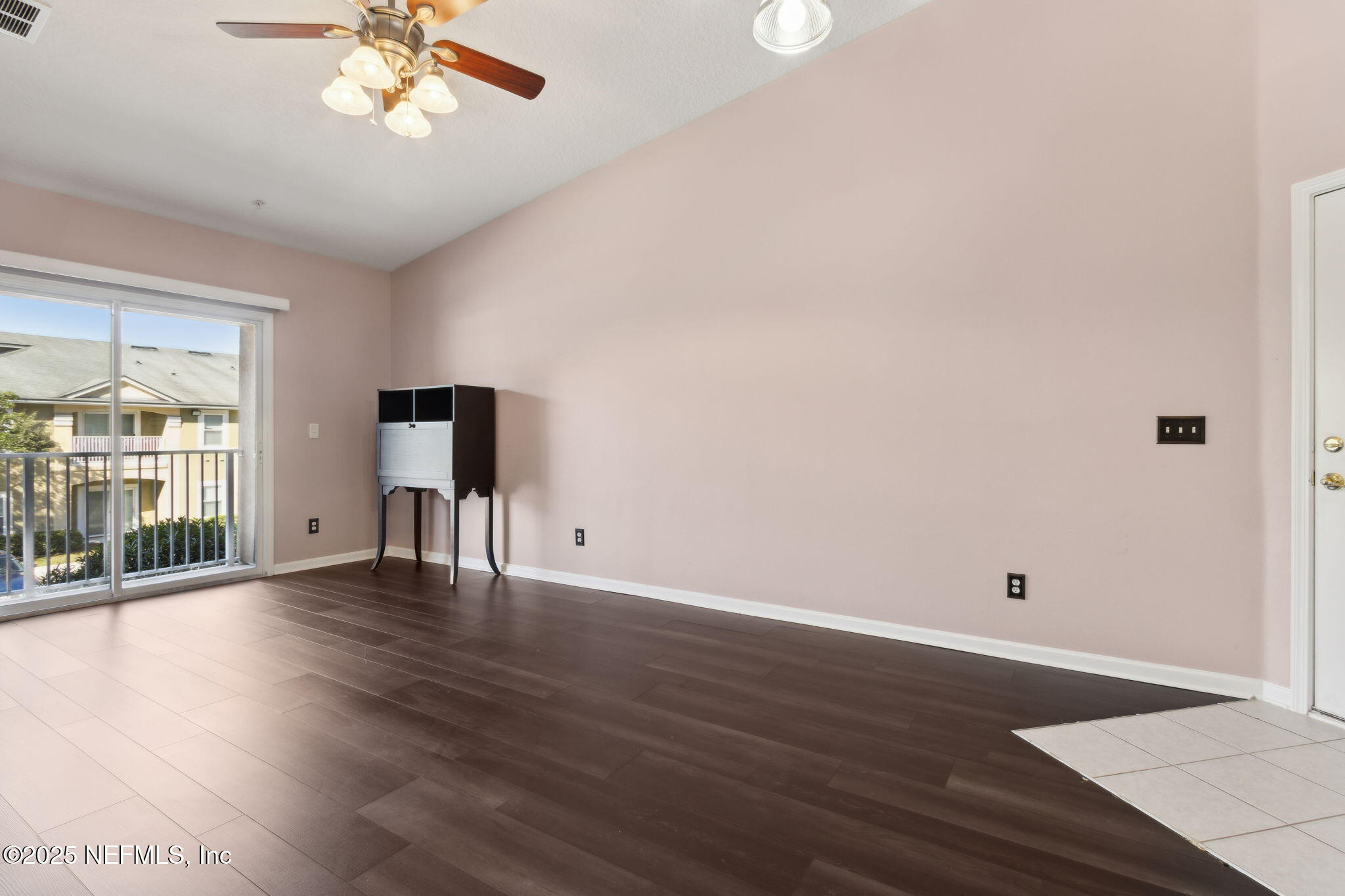 3700 Kirkpatrick Circle, Unit 811 Jacksonville, FL 32210 - Photo 6 of 29 a view of an empty room with wooden floor and a window