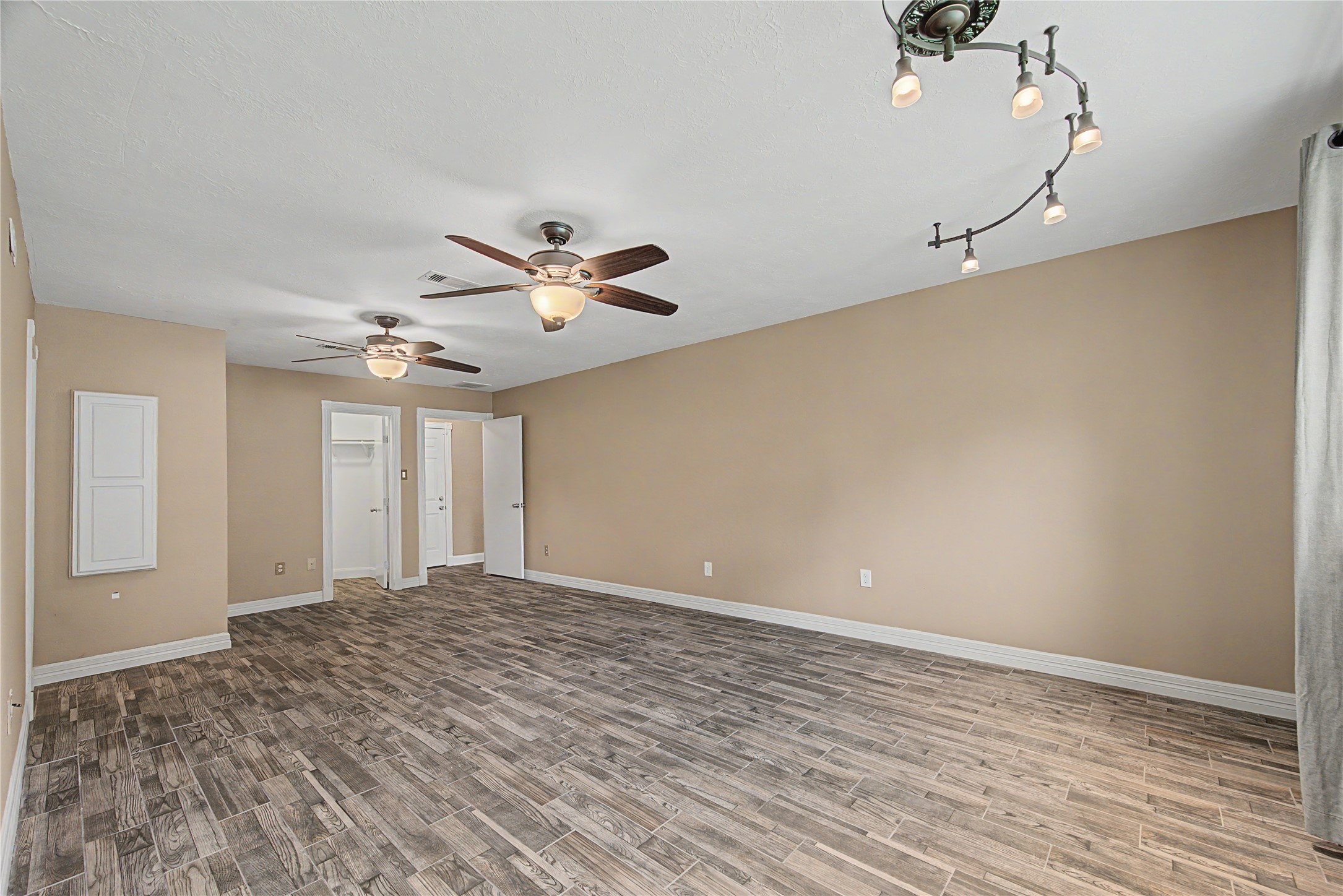4210 Mossygate Drive Spring, TX 77373 - Photo 21 of 33 Another view of the huge primary suite with a peek of the built-in ironing board cabinet on the left — one of many custom features throughout the home!