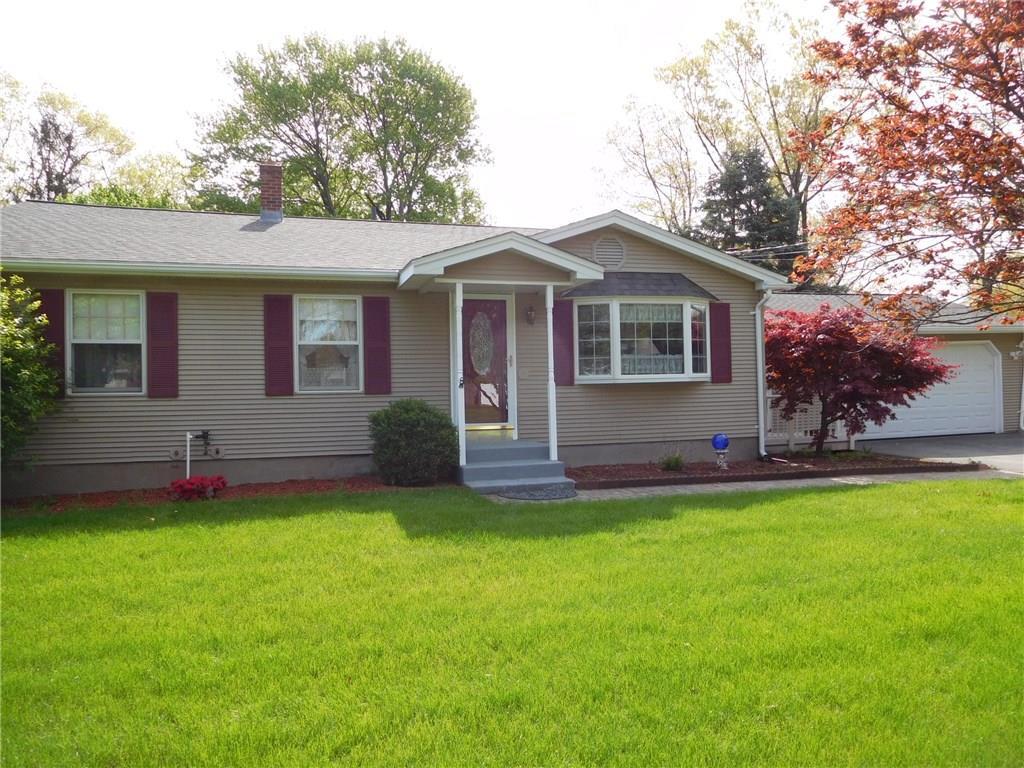 a front view of a house with a yard and trees