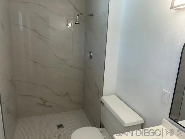 13520 Carriage Road Poway, CA 92064 - Photo 11 of 19 a white toilet sitting next to a bath tub and a shower