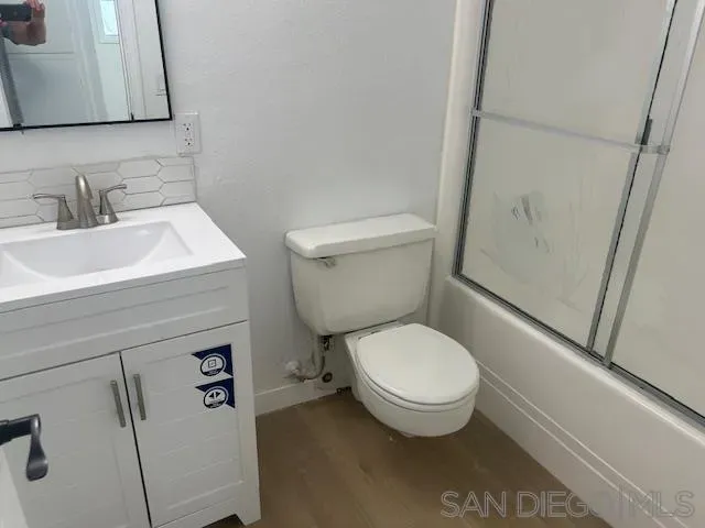 a white toilet sitting next to a bathroom sink