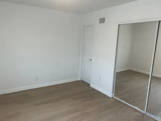 an empty room with wooden floor