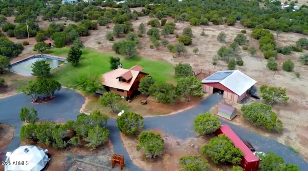 an aerial view of a house with a yard
