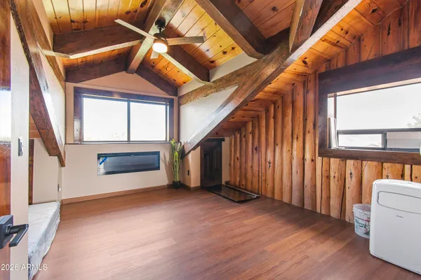 a view of an entryway with wooden floor and door