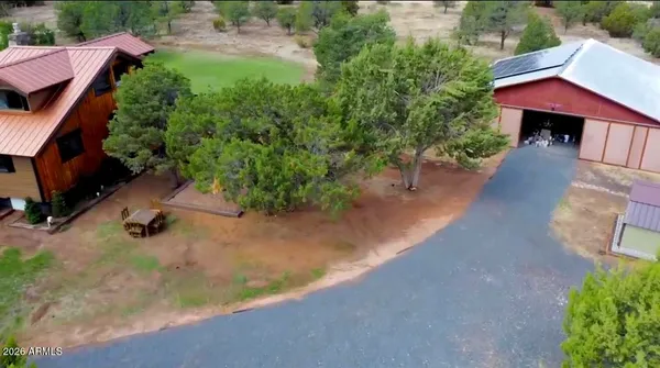 an aerial view of a house with a yard and lake view