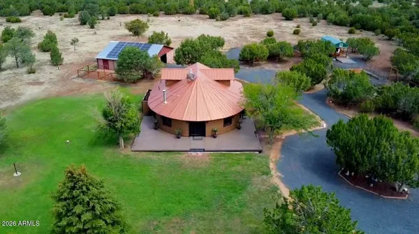 an aerial view of residential houses with outdoor space and lake view