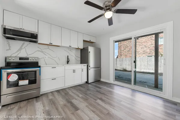 a kitchen with stainless steel appliances a stove a sink and a refrigerator