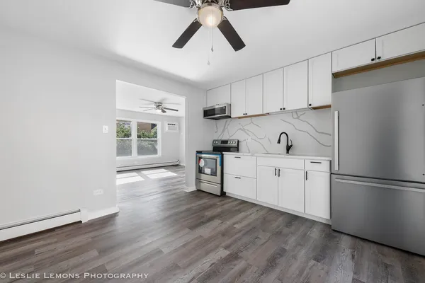 a kitchen with stainless steel appliances a refrigerator sink and cabinets