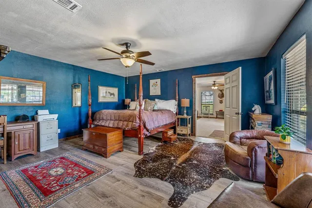 a bedroom with a bed a couch and dresser