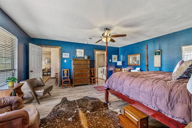 a bathroom with a granite countertop toilet a mirror and a sink