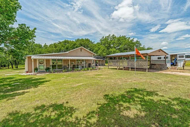 a house with swimming pool in front of it