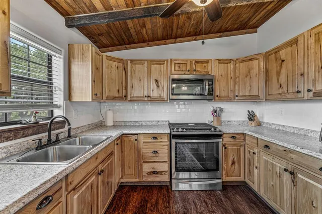 a bedroom with a bed couch and a large window