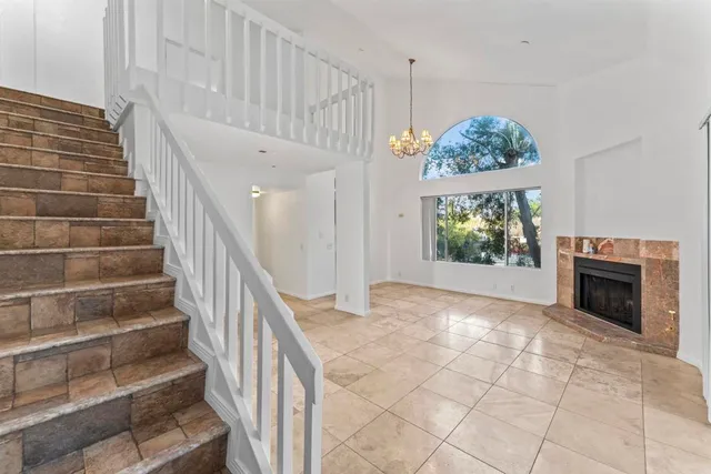 a view of entryway and hall with a fireplace