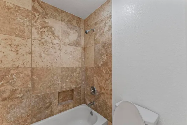 a bathroom with a toilet and shower