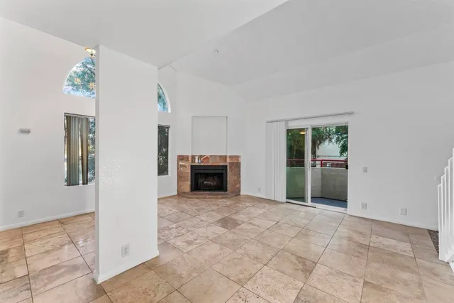 a view of an empty room with a fireplace