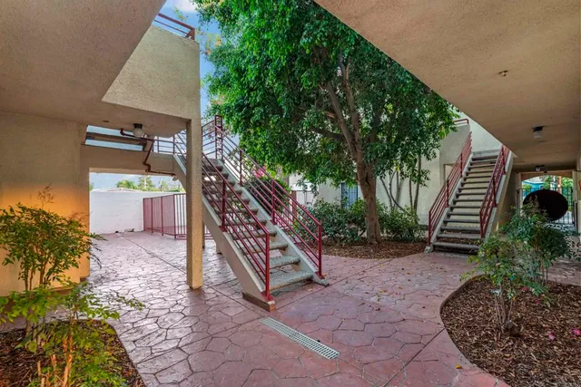 a view of a house with glass door and furniture