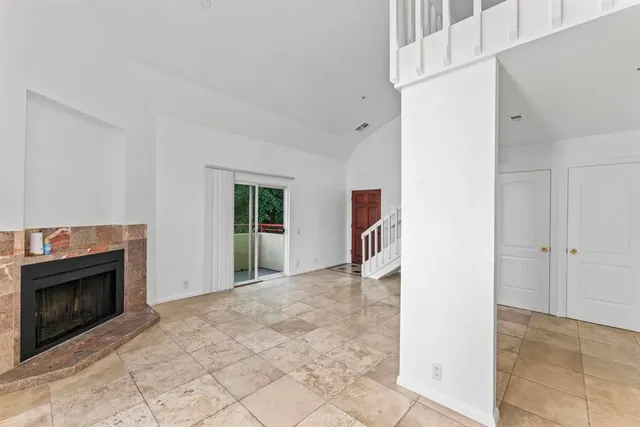 a view of a livingroom with an empty space and a fireplace