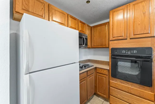 a kitchen with a refrigerator and a stove