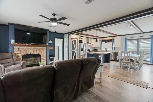 a kitchen with stainless steel appliances granite countertop a refrigerator a sink and a stove