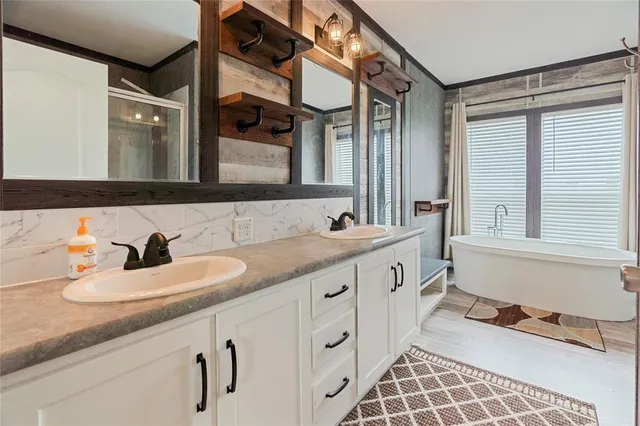 a bathroom with a granite countertop sink a toilet and a shower