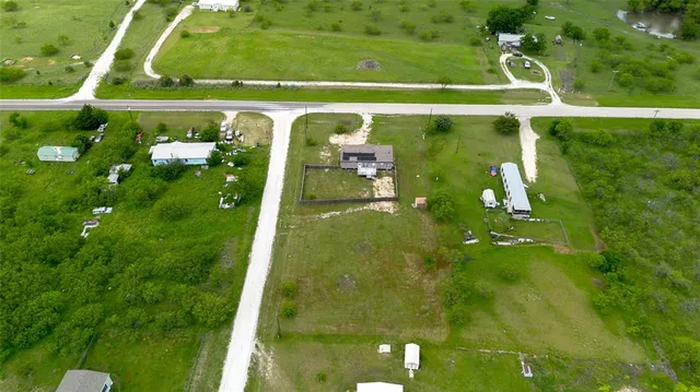 an aerial view of residential houses with outdoor space and swimming pool