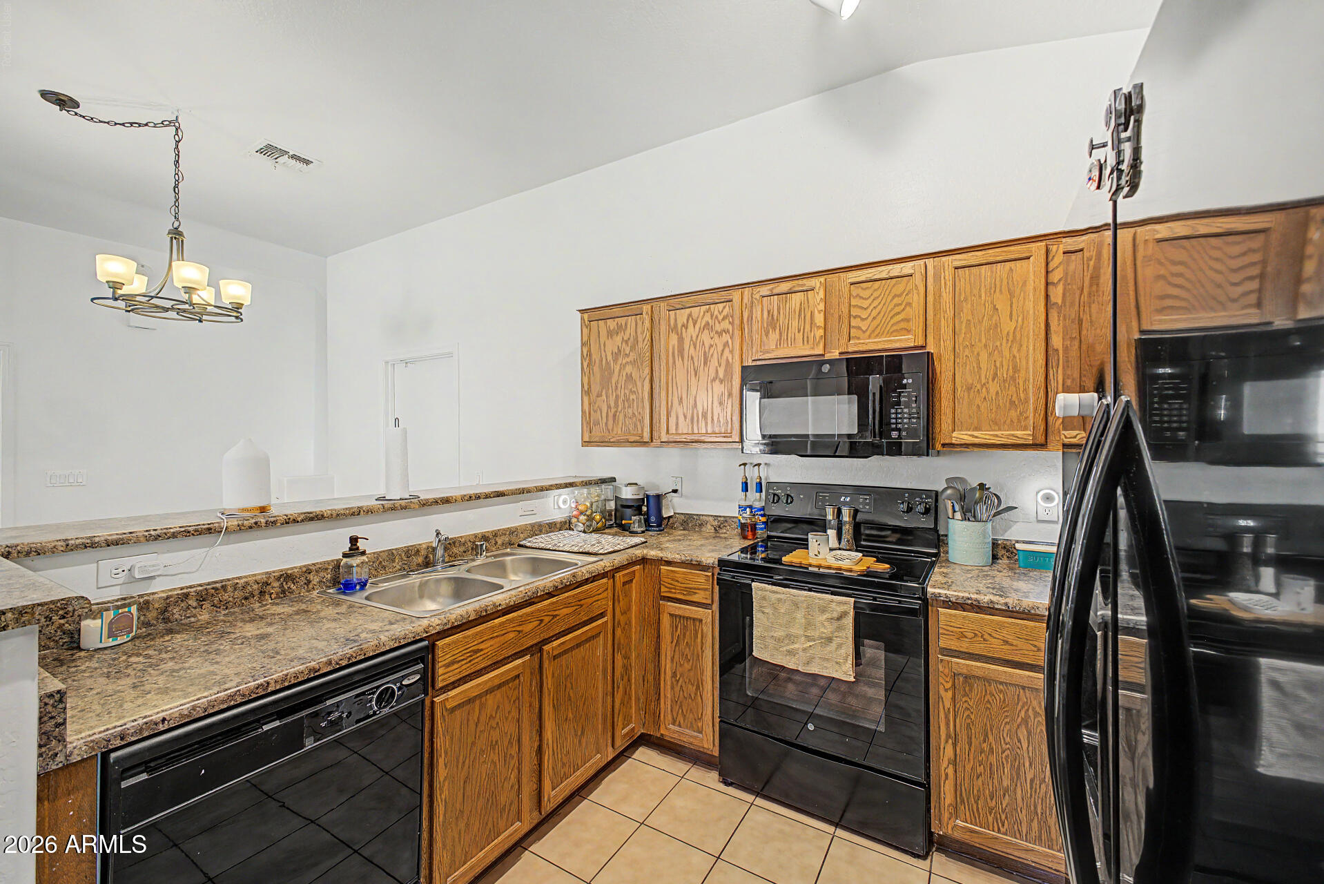 2150 East Bell Road, Unit 1089 Phoenix, AZ 85022 - Photo 10 of 20 a kitchen with stainless steel appliances a sink stove and microwave