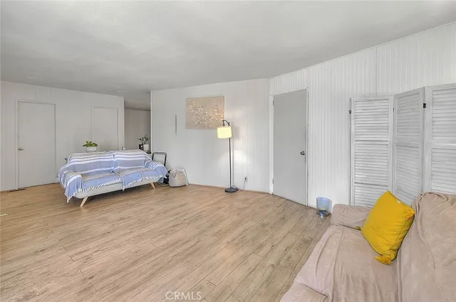 a kitchen with stainless steel appliances kitchen island granite countertop a table chairs and a refrigerator