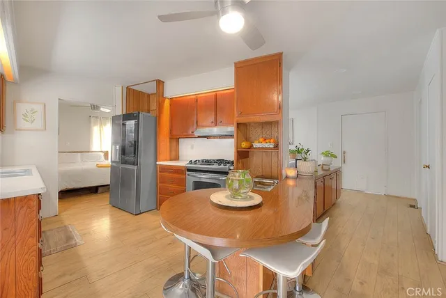a kitchen with stainless steel appliances a stove a sink dishwasher and cabinets with wooden floor