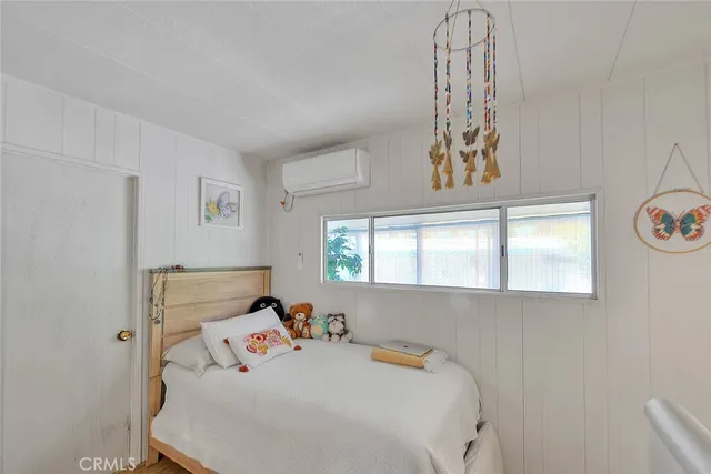 a bedroom with bed and a tv