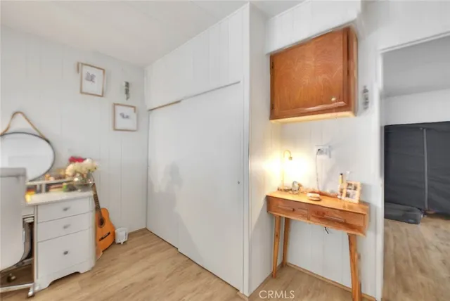 a bedroom with a bed and a large mirror