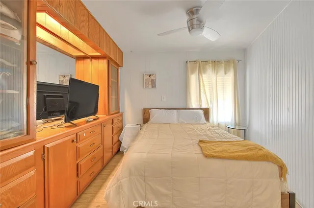 a view of a hallway with furniture and a window