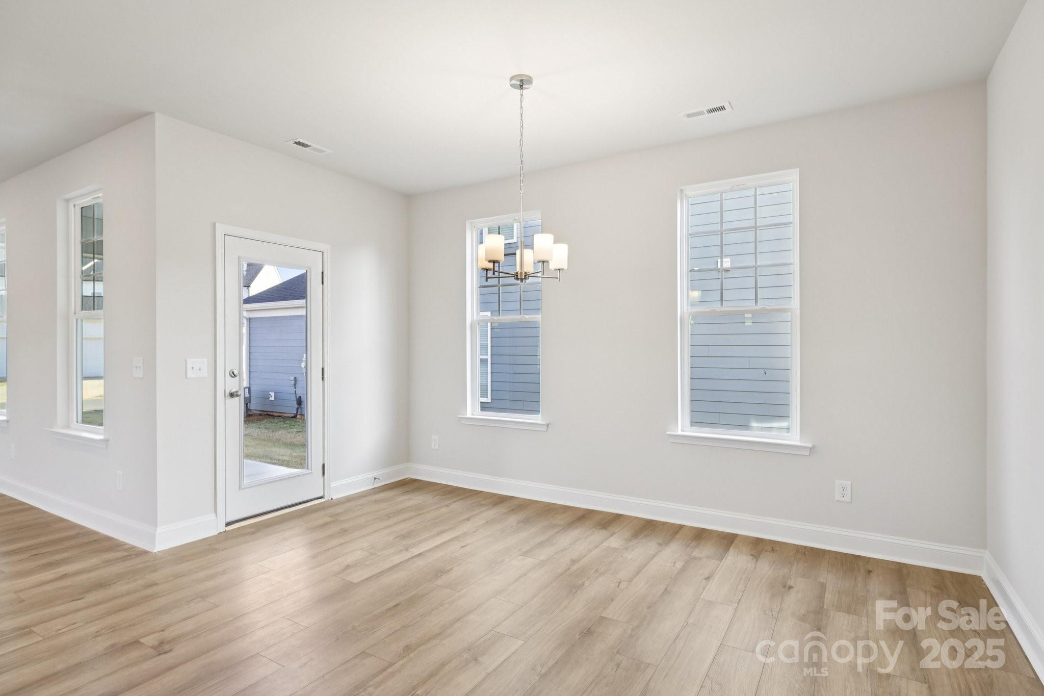 9612 Pointer Road, Unit 59 Huntersville, NC 28078 - Photo 11 of 43 an empty room with wooden floor and windows