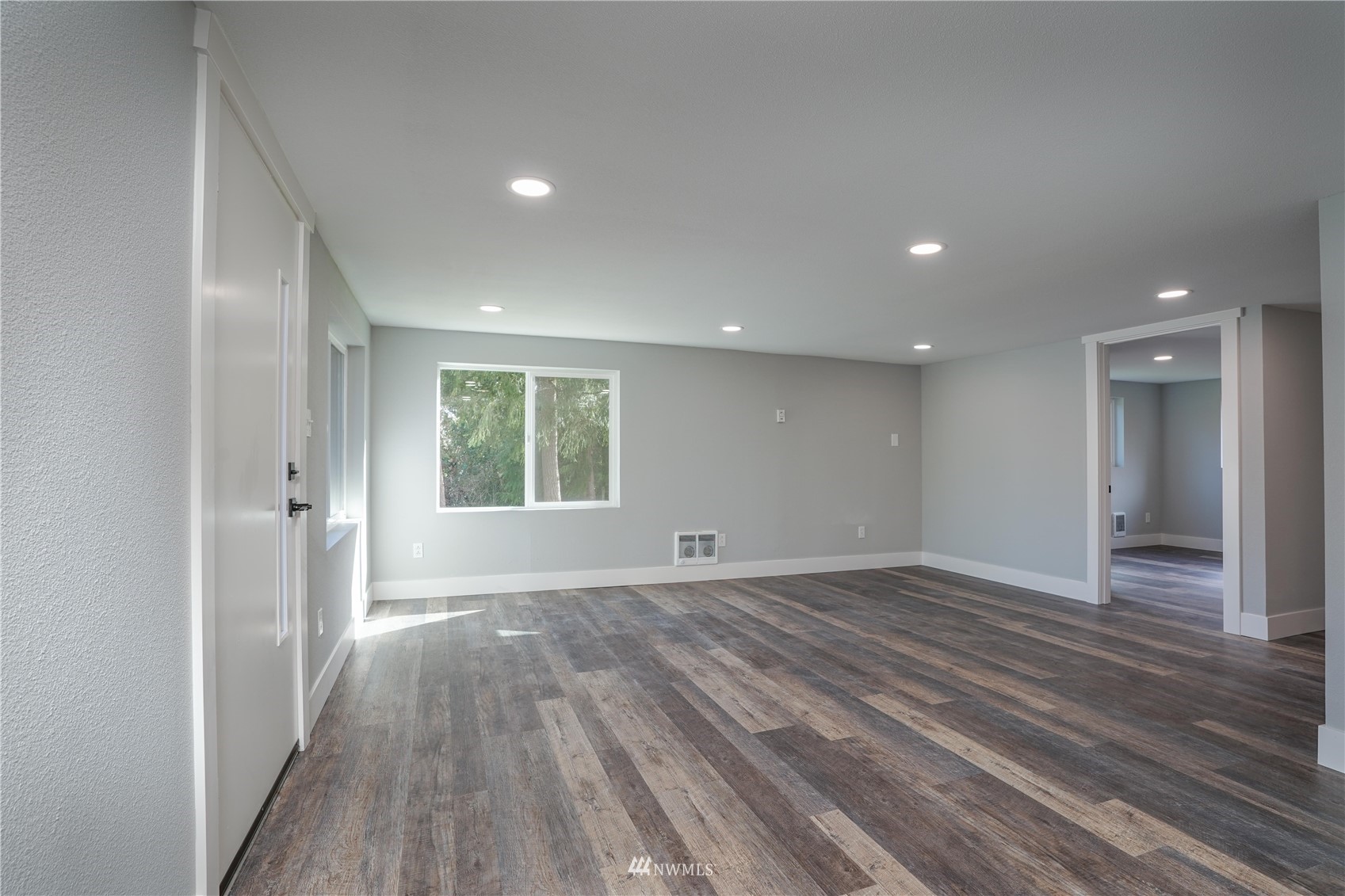 8126 Canyon Road East Puyallup, WA 98371 - Photo 12 of 37 an empty room with wooden floor and windows