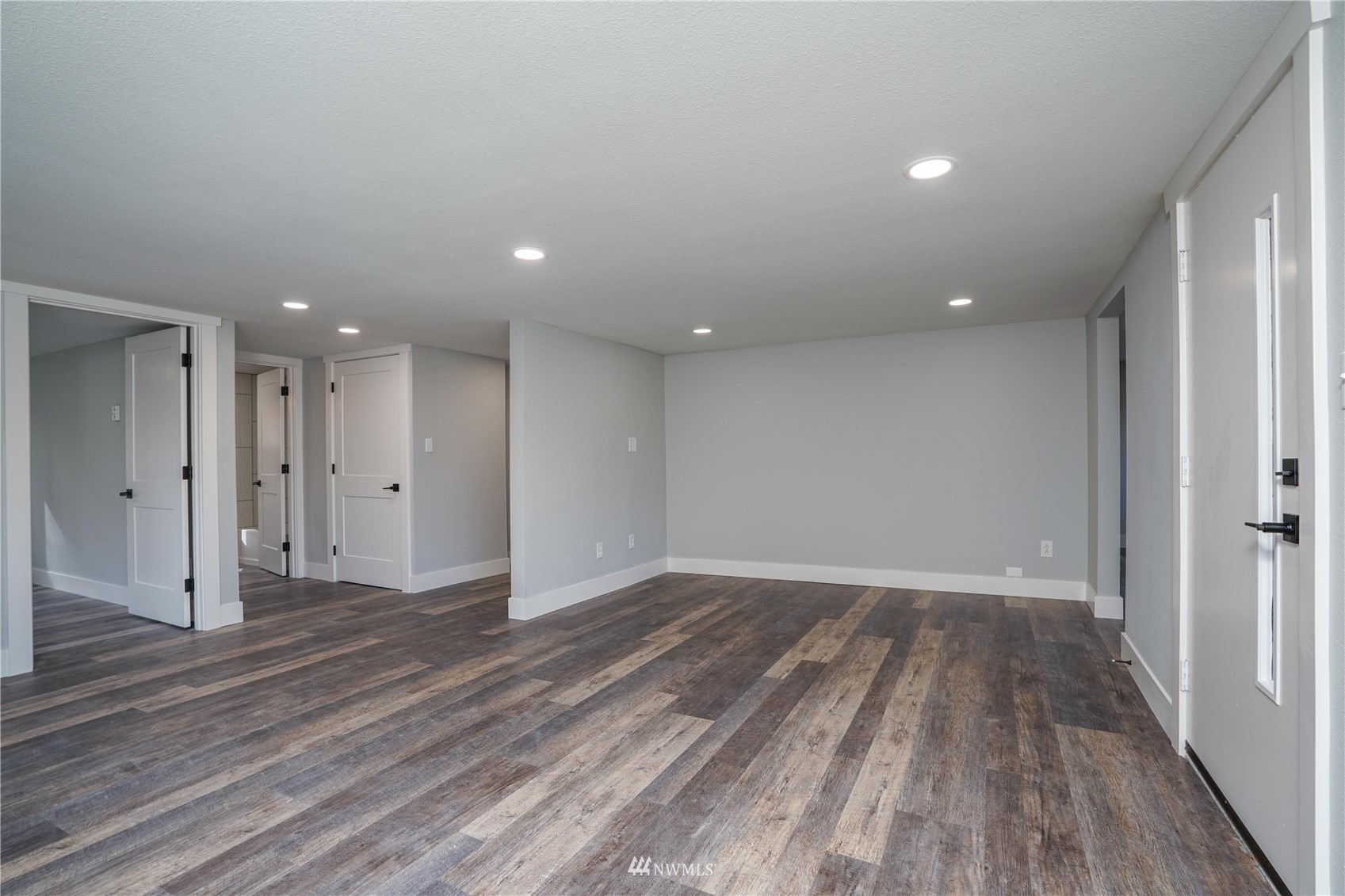 8126 Canyon Road East Puyallup, WA 98371 - Photo 13 of 37 a view of an empty room with wooden floor